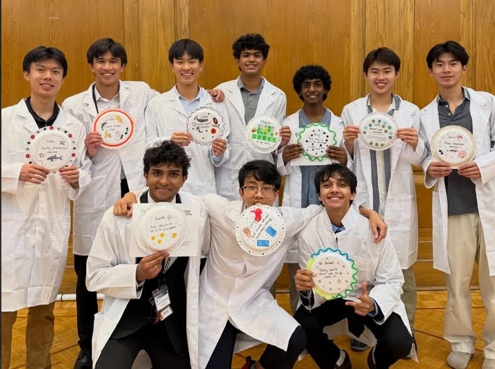 SSP participants in lab coats holding decorated plates